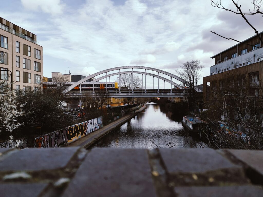 bridge over river near building during daytime