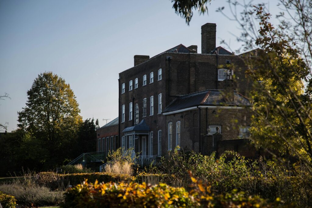 a large brick building surrounded by trees and bushes