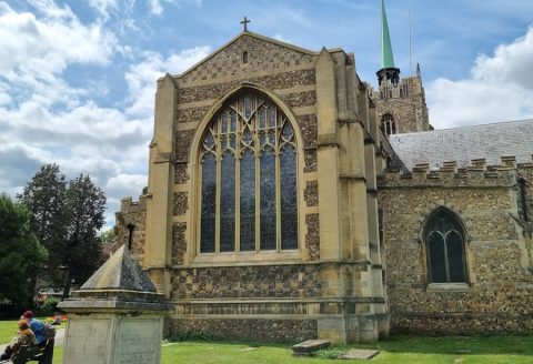 an old church with a statue in front of it