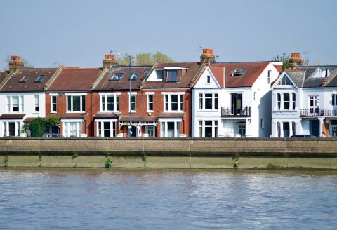white and brown concrete building beside body of water during daytime