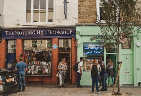 people walking on sidewalk near UNKs store during daytime